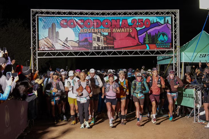 Runners leaving the Cocodona 250 start line at night