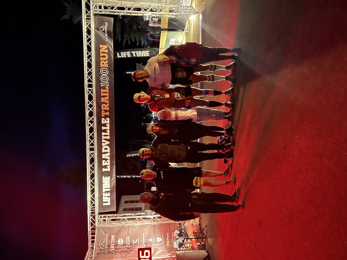Pierce Showe and his crew under the Leadville Trail 100 Run finish arch in 2022