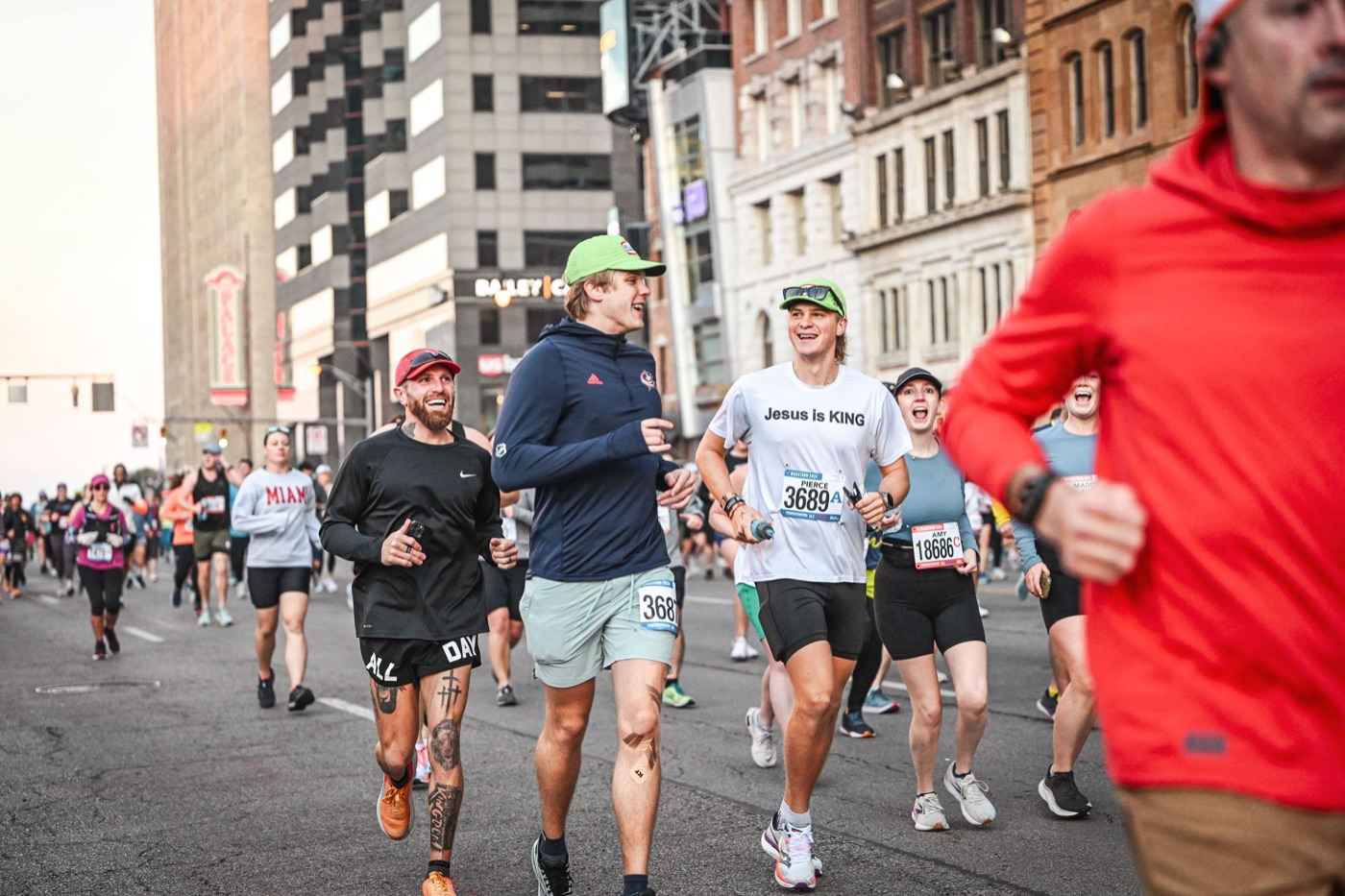 Pierce Showe smiling with friends while running a city marathon in 2024