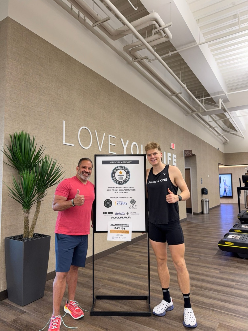 Pierce Showe giving a thumbs up next to the Guinness World Records official attempt sign showing Day 104