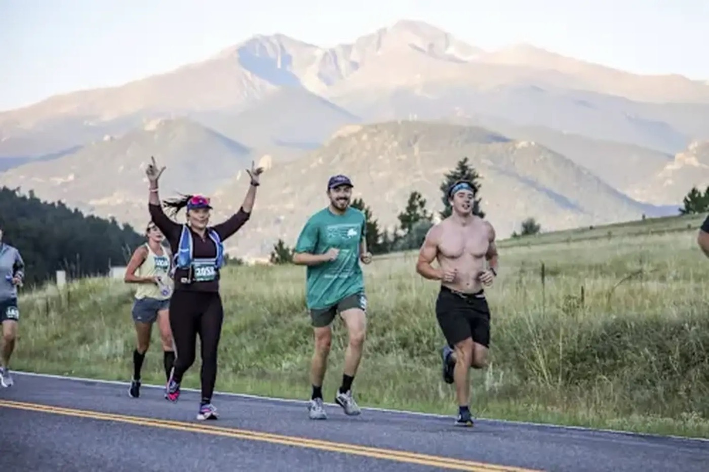 Runners on the Rocky Mountain Half Marathon with mountains behind them