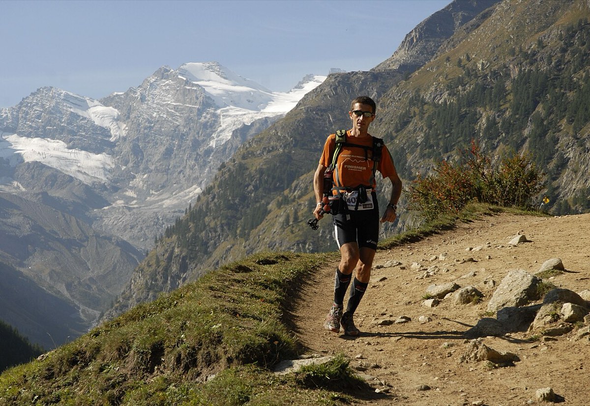 A Tor des Géants runner on a mountain trail in the Aosta Valley, Italy