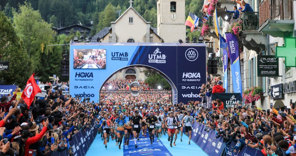 Thousands of spectators cheering runners at the start of UTMB in Chamonix, France
